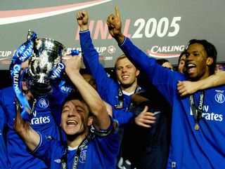 CARDIFF, United Kingdom: Chelsea's captain John Terry holds up the Carling Cup trophy with his teammates after defeating Liverpool in the Carling Cup Final football match at the Millennium Dome in Cardiff, Wales, 27 February, 2005. Chelsea won 3-2 in extra time. AFP PHOTO/REBECCA NADEN NO TELCOS, WEBSITES SUBJECT TO SUBCRIPTION OF LICENCE WITH FAPL AT WWW.FAPLWEB.COM (Photo credit should read REBECCA NADEN/AFP via Getty Images)