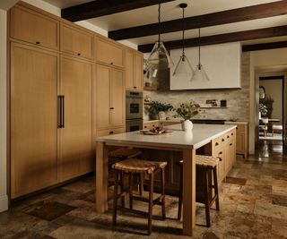 Custom cabinetry and transitional design in a warm, inviting kitchen is a spanish-style home