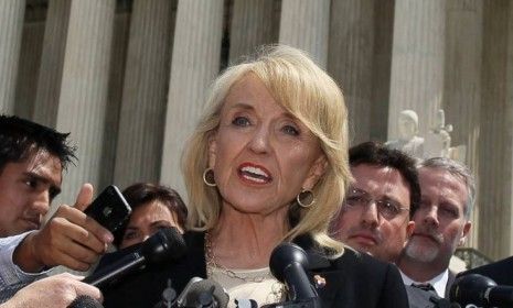 Arizona Gov. Jan Brewer speaks to the media after arguments at the Supreme Court in April: On Monday, Brewer hailed the court&amp;#039;s decision to uphold parts of her state&amp;#039;s controversial immigrati