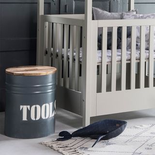 Tools storage bin from cuckooland next to a cot