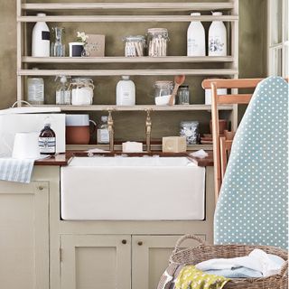 utility room, butler belfast sink, storage shelves, assorted storage jars storing wooden dolly pegs and cleaning products