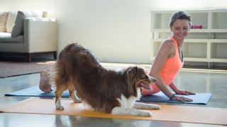 woman and dog doing yoga