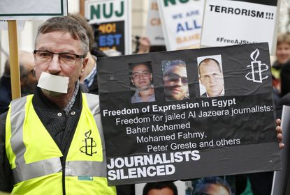 A demonstrator calls for journalists' release 