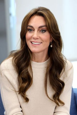 Kate Middleton headshot with a middle parted wavy hairstyle