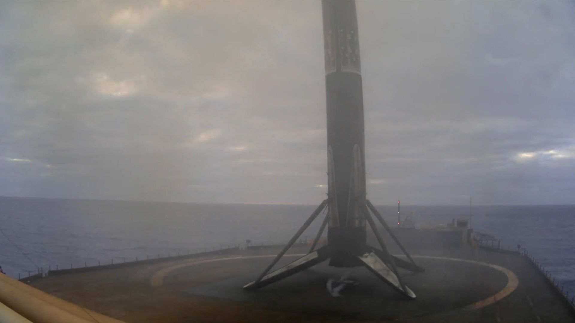 a rocket rests on the deck of a ship at sea