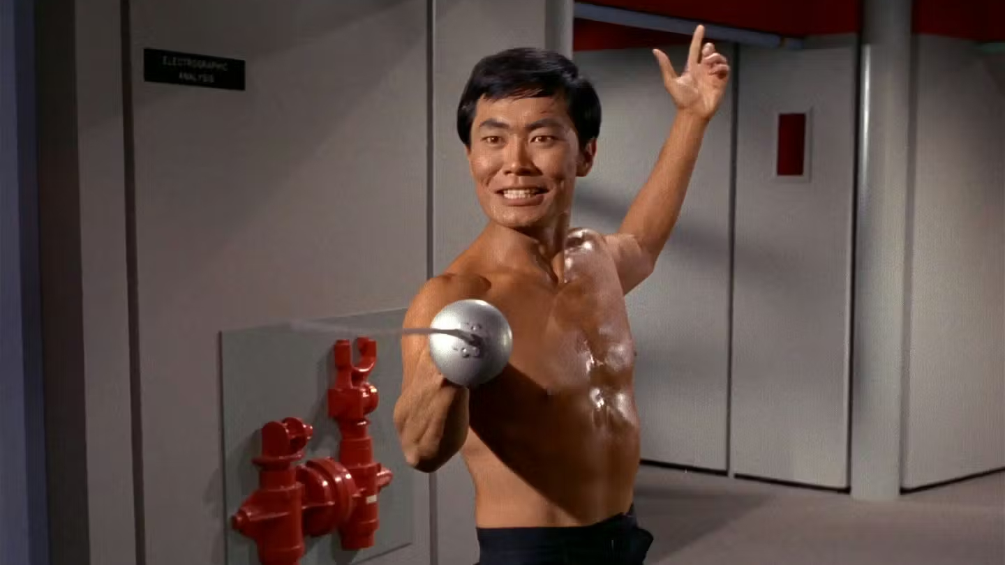 Screenshot from Star Trek: The Original Series showing Hikaru Sulu, played by George Takei, shirtless and brandishing his fencing sword.