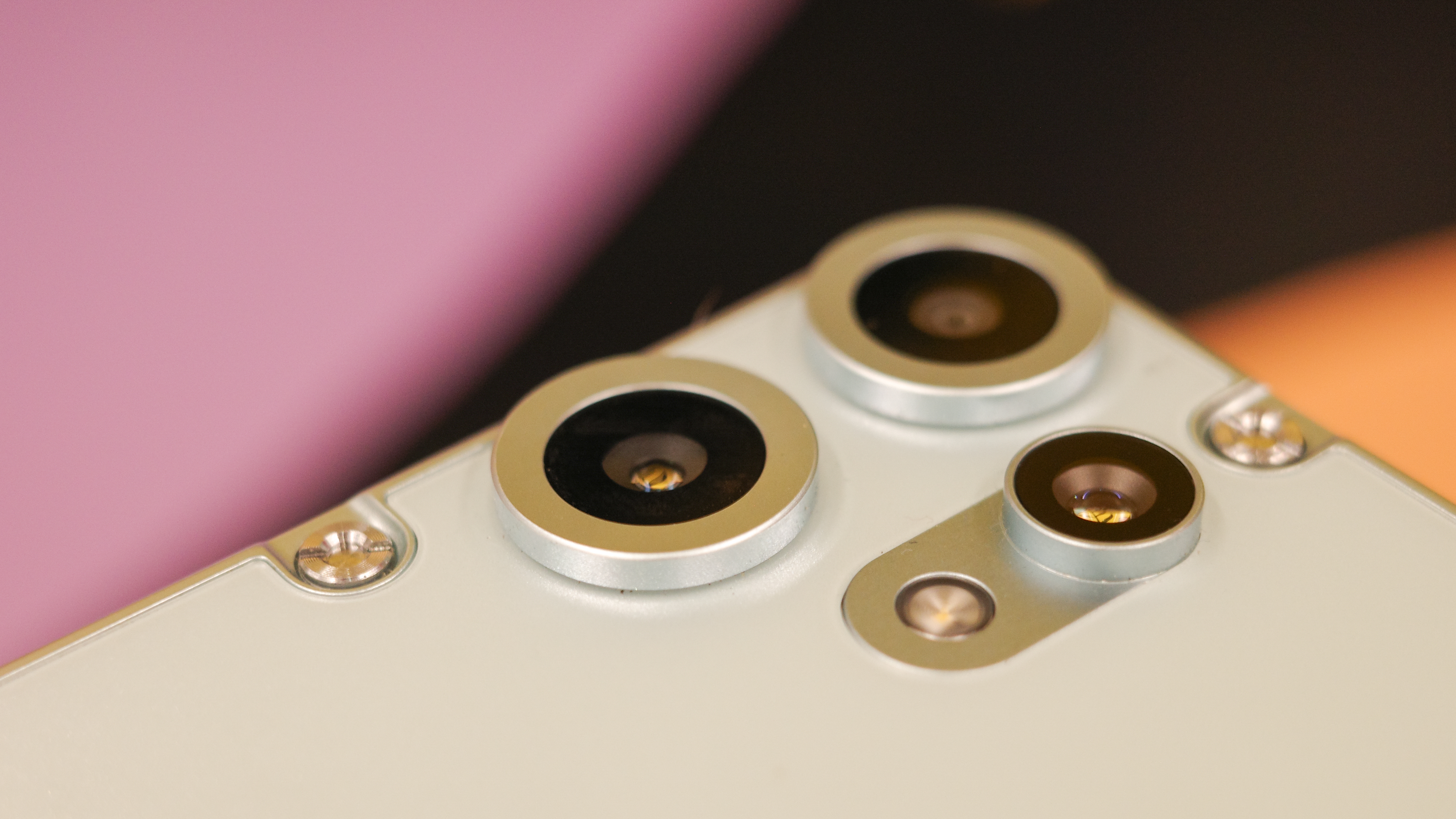 Rear of CMF Phone 2 Pro in light green showing exposed screws and cameras