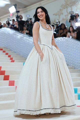 Dua Lipa arrives on the Met Gala 2023 red carpet wearing a corseted Chanel dress