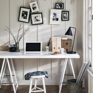 home office with white table and laptop