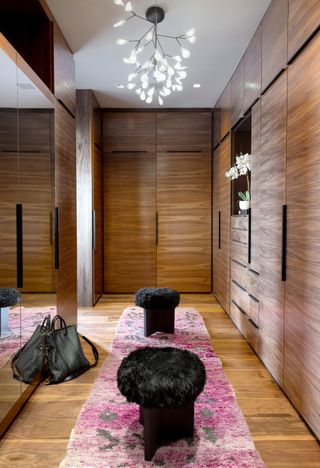 A walk in closet with storage from floor to ceiling