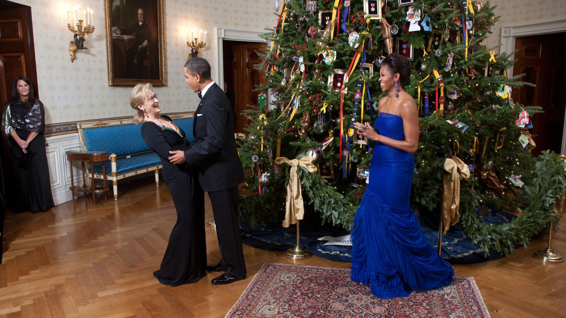 Meryl Streep embraces then President Barrack Obama after she receives her Kennedy Centre Honours in the shadow of a giant Christmas tree