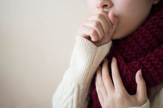 A woman coughing.