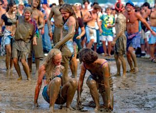 Two girls covered in mud in a crowd at Woodstock 94