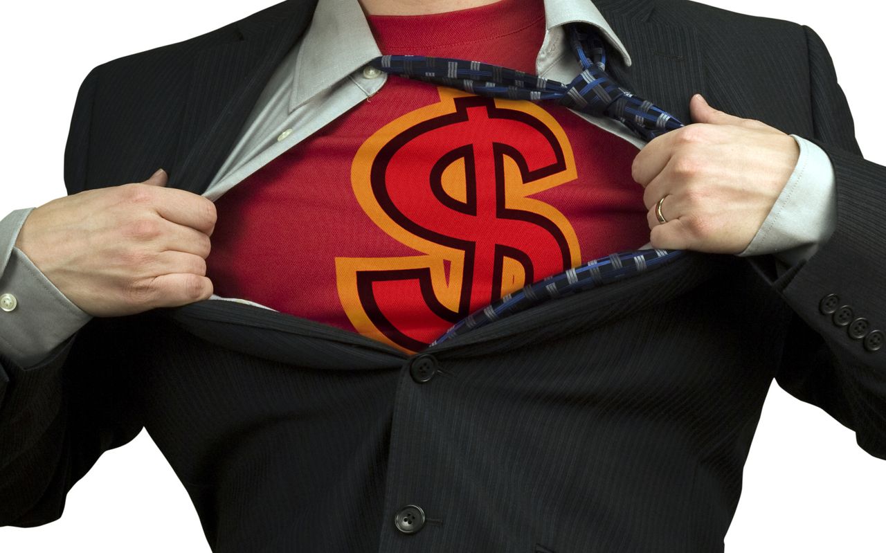 Shot of a man&#039;s chest as he pulls apart a business suit to reveal a superhero costume with a dollar sign on it.