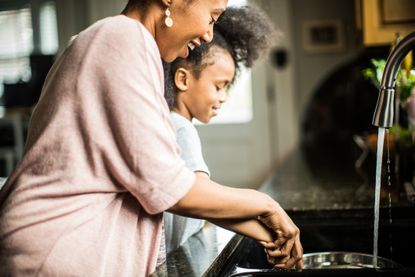 How do I reduce my water usage: A mum and daughter doing dishes