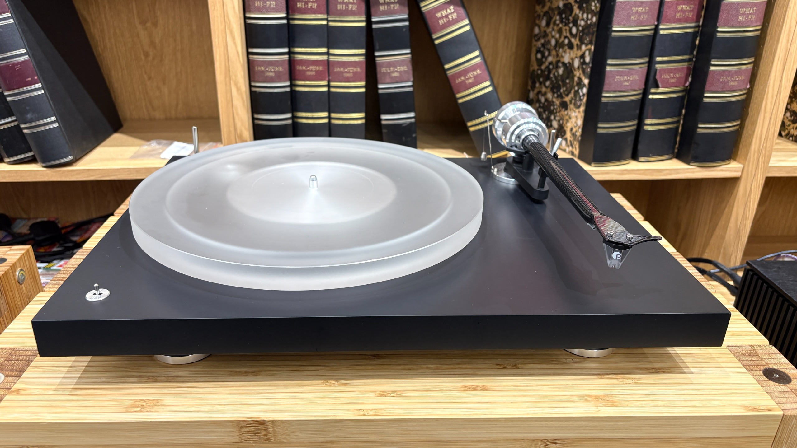 Pro-Ject Debut Reference 10 turntable on wooden shelf