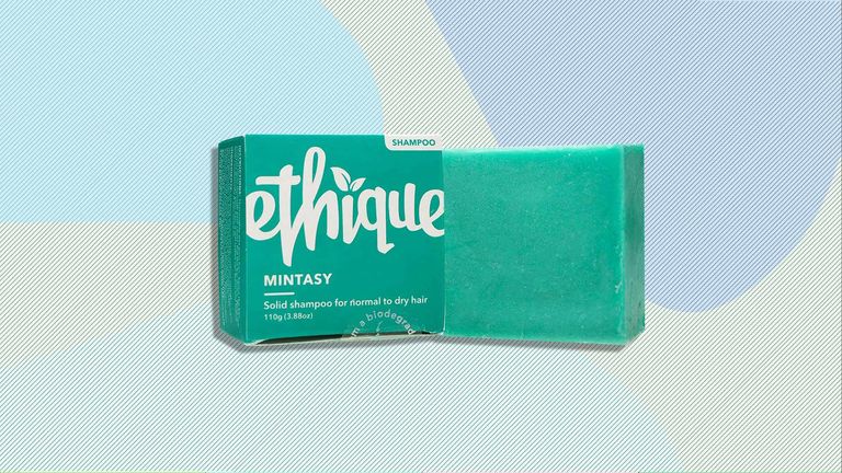 The Ethique Mintasy Shampoo bar and box is pictured on top of a computed generated background design with colored blobs and lines