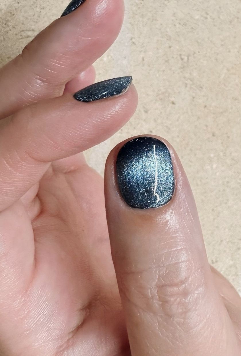 a close-up shot of deep blue velvet nails