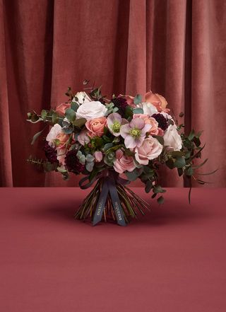 McQueen's flowers of London, Seoul, and New York bouquet of pink and white flowers and green stems against pink background