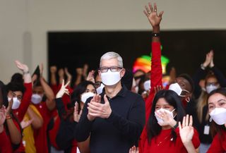 Apple CEO Tim Cook clapping in front of a crowd of workers at the opening event of the new Apple store at The Grove in Los Angeles, California