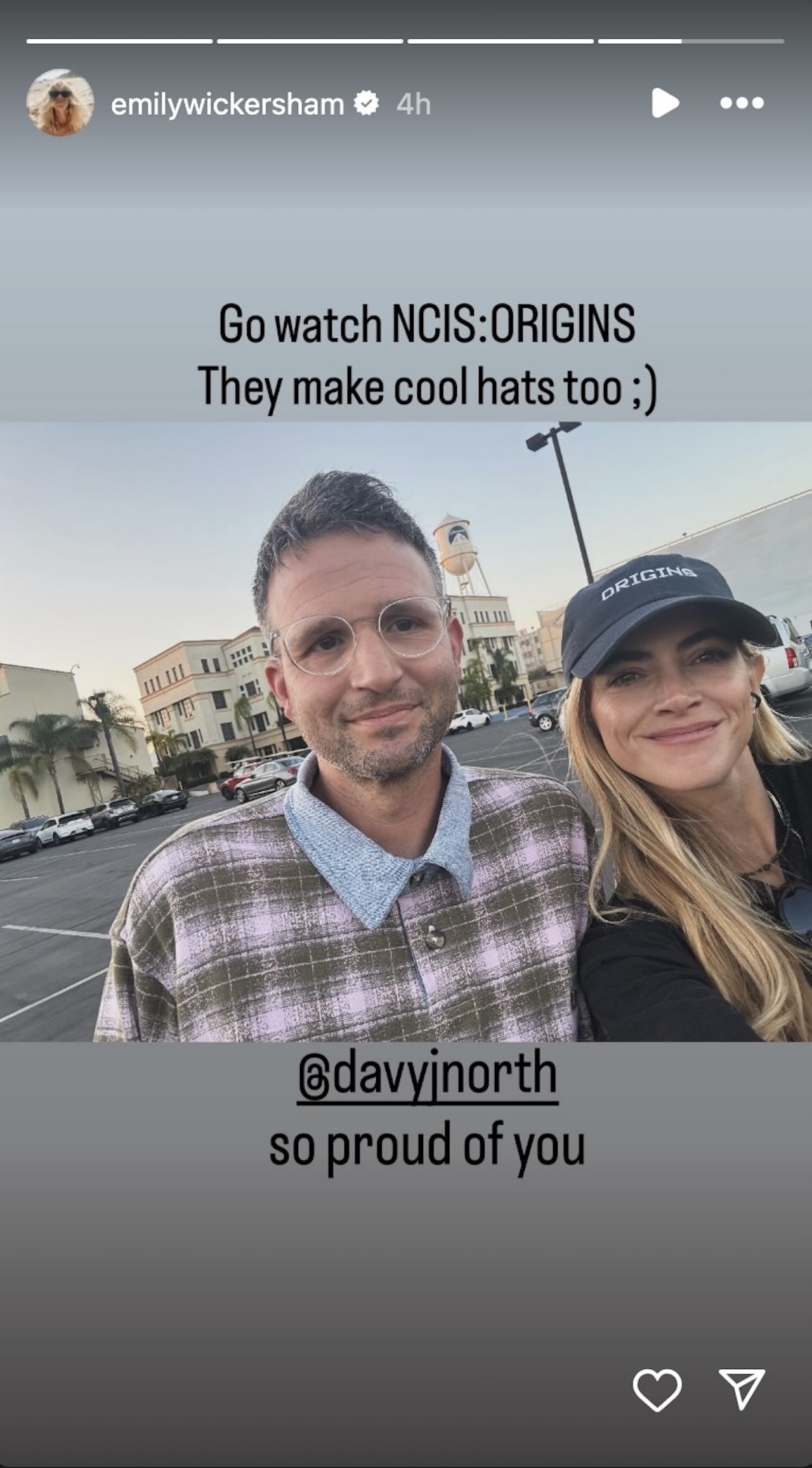 Instagram Story of Emily Wickersham and David J. North standing next to each other outside, Wickersham wearing an NCIS: Origins hat