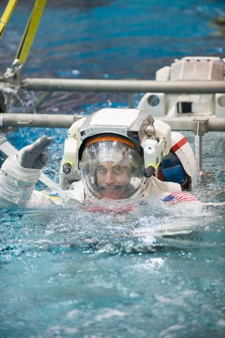 NASA astronaut Chris Cassidy, Expedition 35/36 flight engineer, attired in a training version of his Extravehicular Mobility Unit (EMU) spacesuit, is submerged in the waters of the Neutral Buoyancy Laboratory (NBL) near NASA's Johnson Space Center.