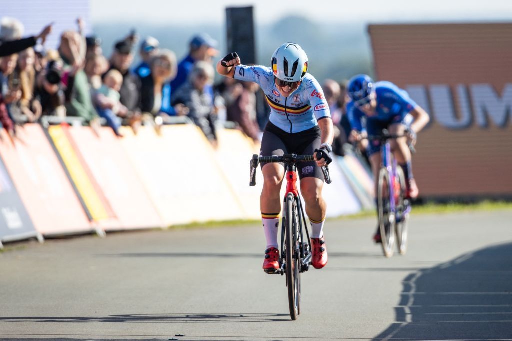 Belgian Fleur Moors celebrates as she crosses the finish line to win the Junior Womens Road Race 69km around and on the Col du VAM on the final day of the UEC Road European Championships 2023