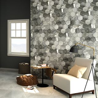 grey ruvido tiles wall with white sofa chair and standing lamp