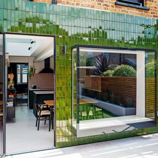 exterior of a house covered in green tiled cladding