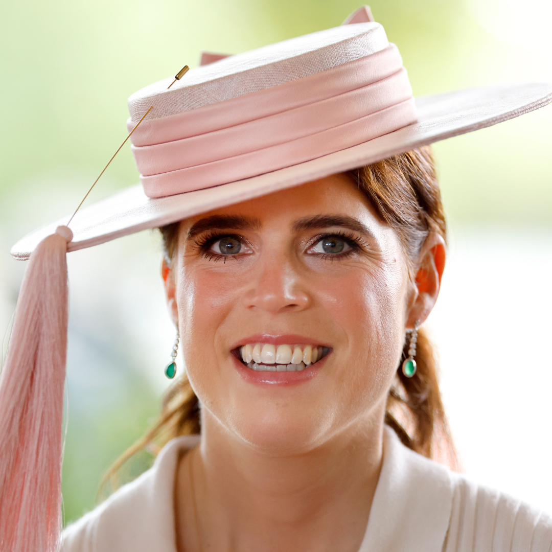 Princess Eugenie wearing a pink hat and smiling