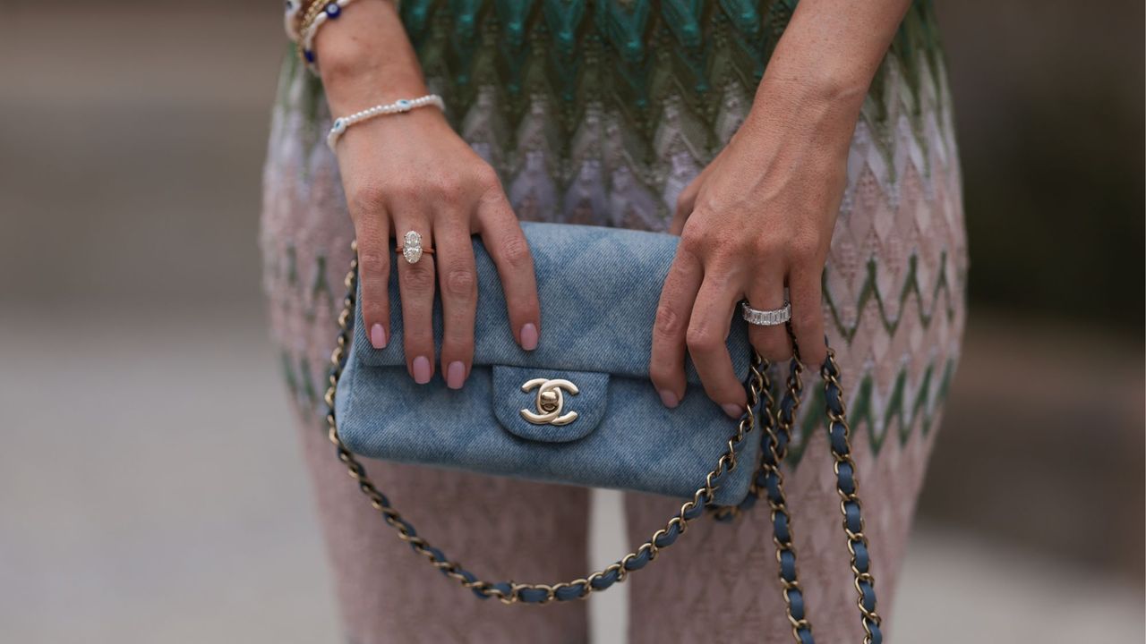 Best Chanel nail polishes - woman holding Chanel handbag with pink manicure