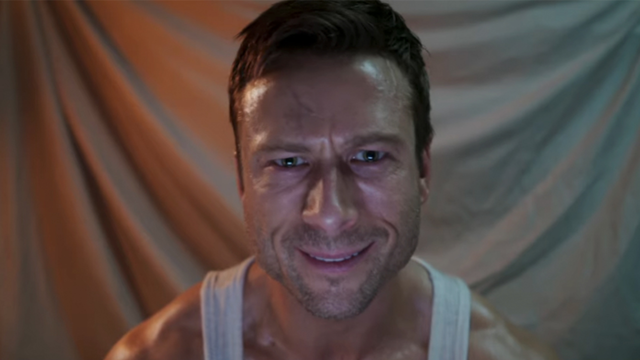 Glen Powell looking directly into the camera in The Running Man