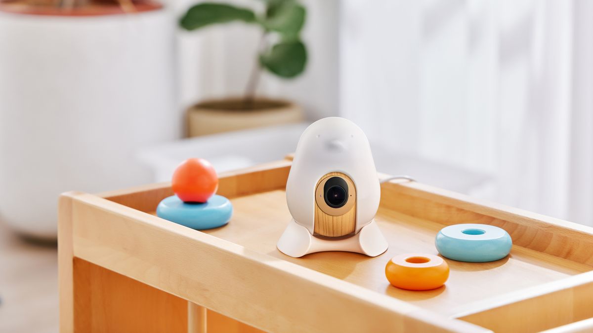 The CuboAi Smart Baby Monitor 3 on a shelf with baby toys