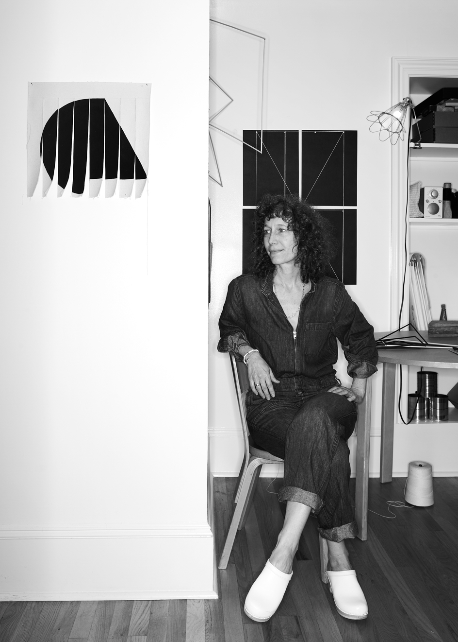 Portrait of Emily Hass in her Avenue A studio featuring Water Shape Canvas, 2021 (left) and String-Nail composition, 2021 (behind)