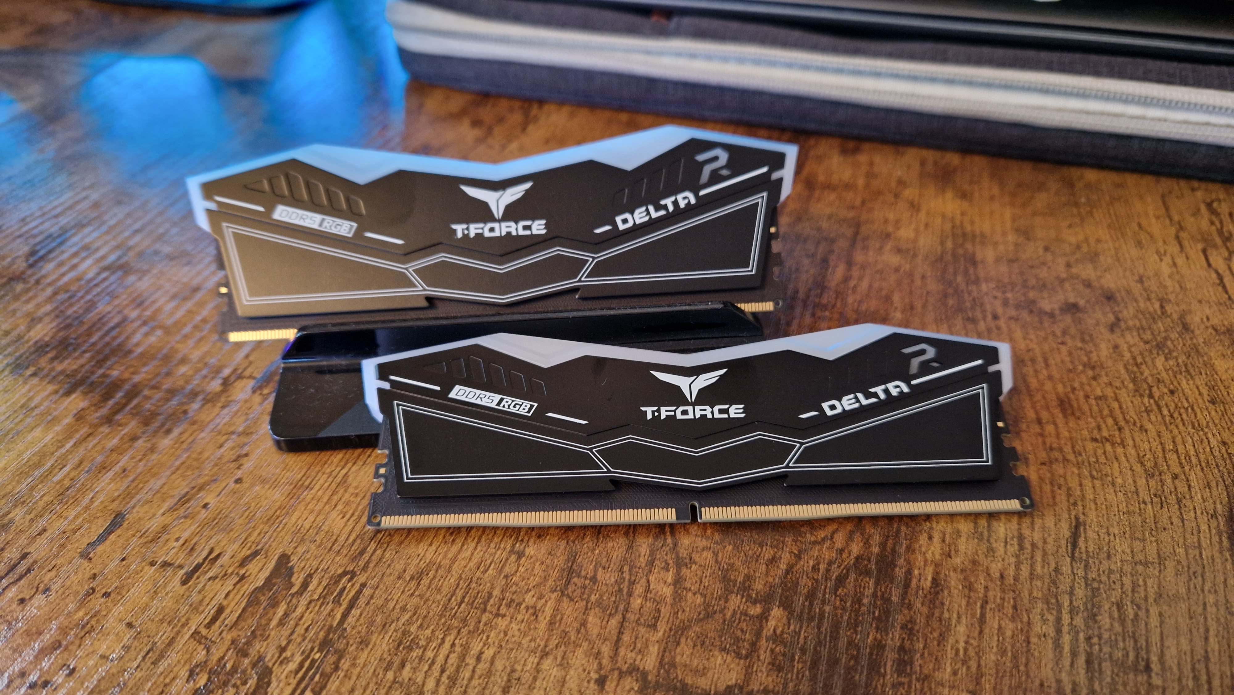 T-Force Delta RGB DDR5 review image of two sticks on a wooden desk