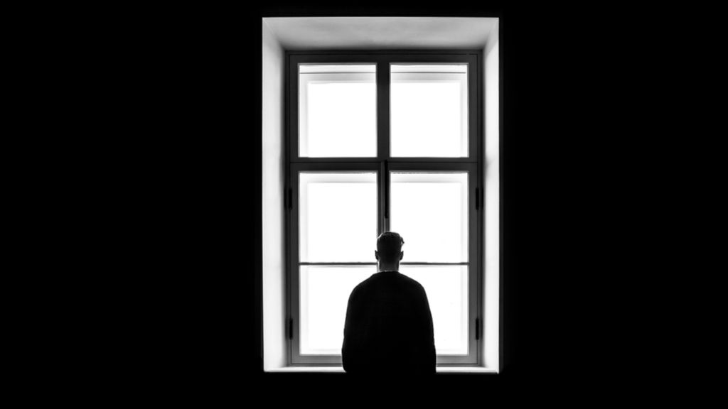 silhouette of man at window