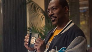 Eddie Murphy holds up a police badge in Beverly Hills Cop: Axel F
