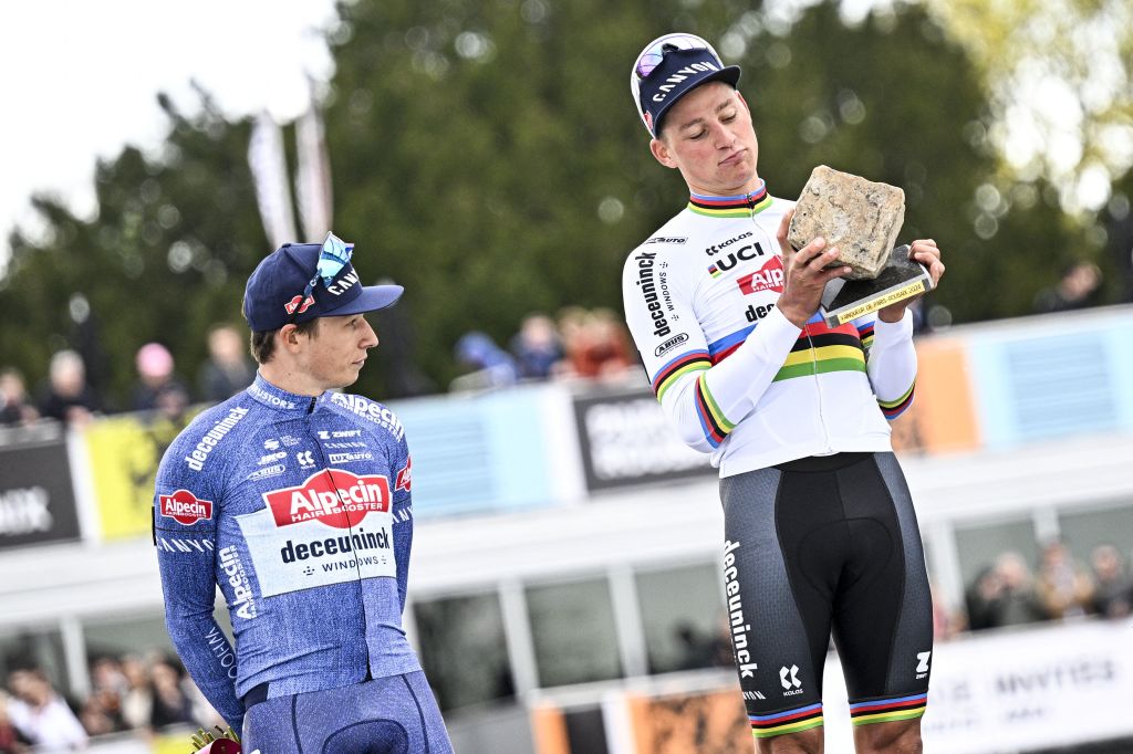 Mathieu van der Poel celebrates with Jasper Philipsen and the Roubaix trophy on the final podium of the 2024 Paris-Roubaix