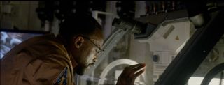 A character from the movie "Life" peers into a sealed hutch that contains a life-form found in a dirt sample from Mars. In reality, detailed science studies in space can be time-consuming and expensive.
