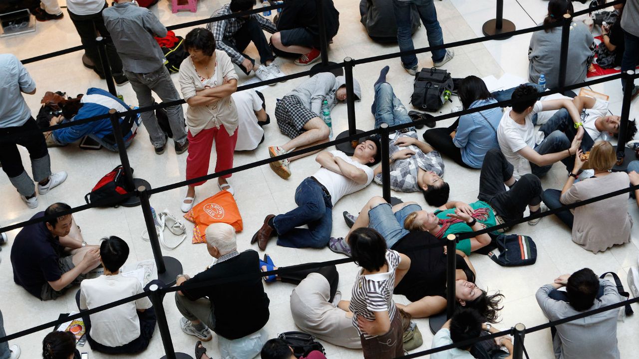 Chinese consumers queue up for the latest Apple iPhone in Beijing