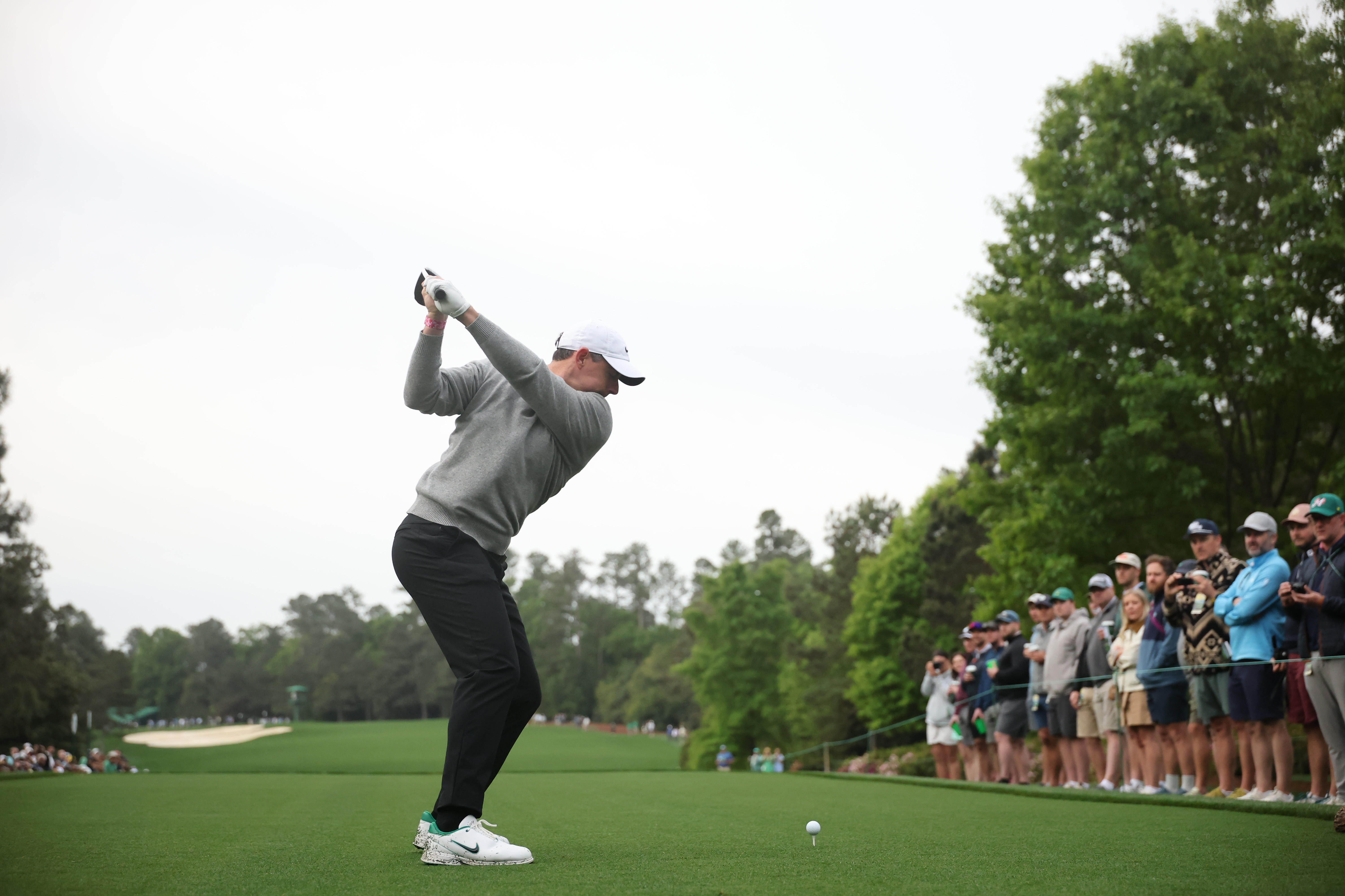 Rory McIlroy plays a shot from the fifth hole tee box during a practice round prior to the 2026 Masters Tournament at Augusta National Golf Club