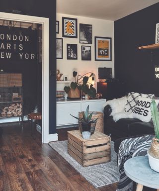 A fruit crate in dark living room with black wall paint decor