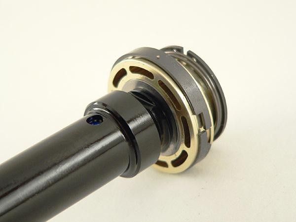 The dedicated high-speed compression damping shim stack sits atop the piston body and is normally preloaded by the black aluminum sleeve (pulled up for easier viewing).