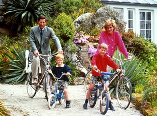 File photo dated 01/06/89 of the Prince and Princess of Wales with sons Prince William, right, and Prince Harry prepare for a cycling trip in Tresco during their holiday in the Scilly Isles, as the 20th anniversary of Diana's death will be commemorated on Thursday. - Image ID: K2J045