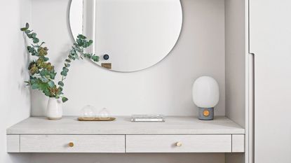 White painted bedroom with built-in vanity with wall mirror