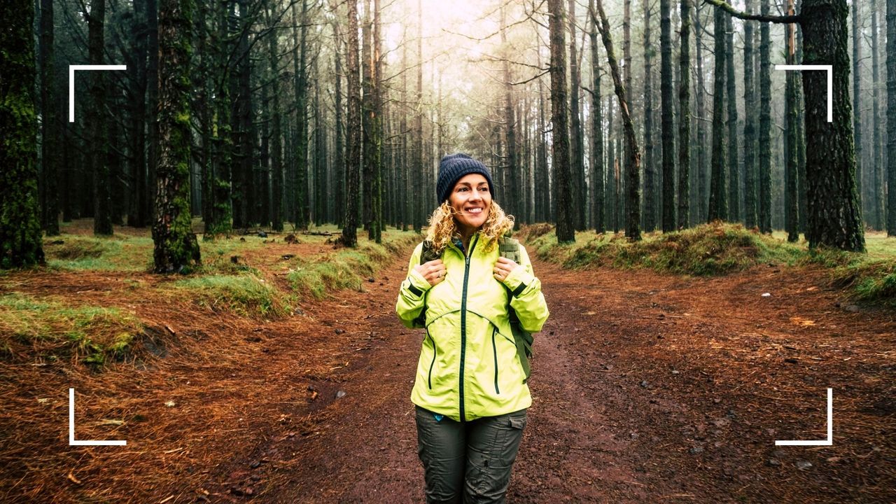 Woman walking through forest