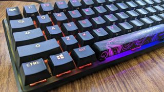 A close up of the HyperX Alloy Origins 60 with RGB lighting turned on