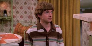 Topher Grace as Eric Forman, getting his butt handed to him because, teenage life