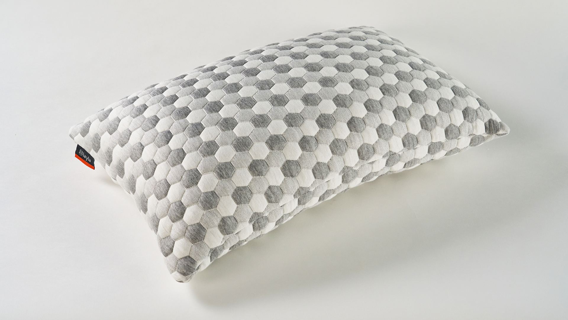 The grey and white kapok pillow against a white background