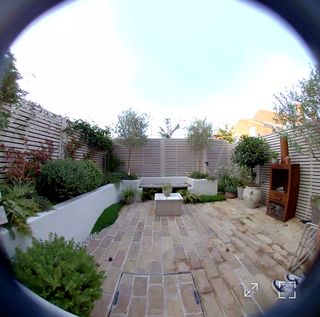 a small courtyard garden seen through a ring doorbell camera